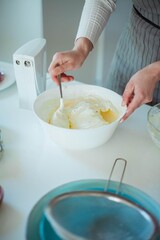 Young beautiful woman bakes a cake. Sweets. Confectionery.