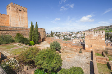 Fototapeta premium A view over old town Granada (Albaicin or Arab Quarter), in Andalusia, Spain on a clear sunny day from the gardens of Charles V Palace at the historic Alhambra.