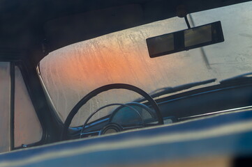 Retro car 1950th-1960th interior (cabin), steering wheel. Early morning, condensation on the...