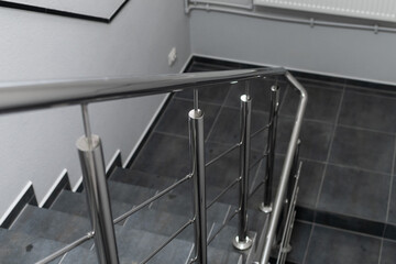Stainless steel handrails and staircase in office premise, selective focus.