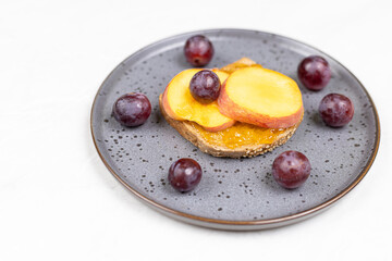 Top view of Peaches served on the plate with grapes