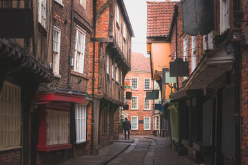 The Shambles in old town York, featuring traditional medieval timber frame overhang buildings, is a popular tourist attraction and shopping area in Yorkshire, England, UK.