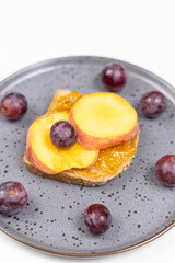 Top view of Peaches served on the plate with grapes