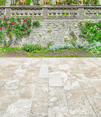 Beautiful garden terrace with rose bush and natural stone paving.