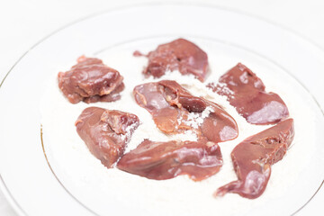 Raw Chicken Liver on the plate with flour