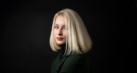 Fototapeta premium close up of pale blonde woman isolated on dark background