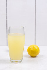 Homemade Lemonade in the glass with lemons on the table