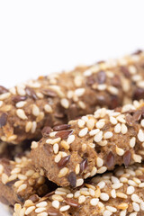 Tasty Sesame sticks closeup above white background.