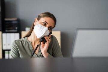 Receptionist On Phone Wearing Face Mask