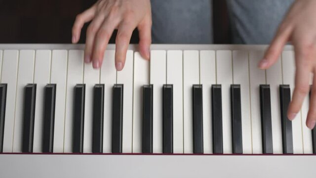 Woman masterly playing the piano. Closeup above view