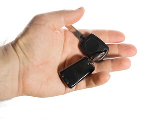a man holds in his hands the keys to a not new car, sells, buys or leases.