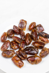 Healthy Dates on the white plate with copy space