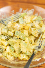 Served Avocado salad with Eggs and Pickles