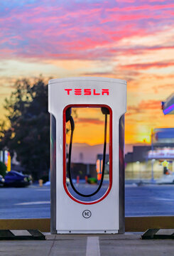 Firebaugh, USA - January 21, 2021: Empty electric Tesla supercharger by California Highway 5 at sunset