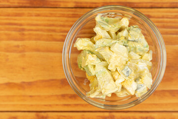 Served Avocado salad with Eggs and Pickles