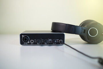 Headphones plugged to an external USB Sound card. Home studio concept.