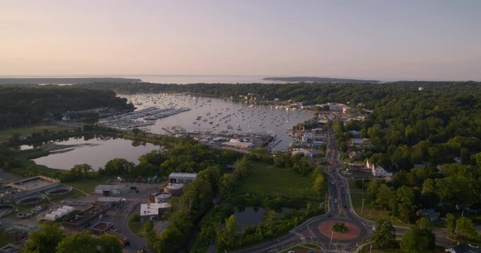 Flying Over Huntington and Towards Boats Docked at Bay During Sunset