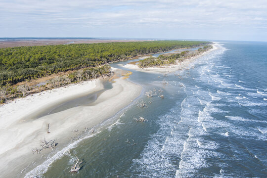 Aerial view of Hunting Island State Park with driftwood along the shore.