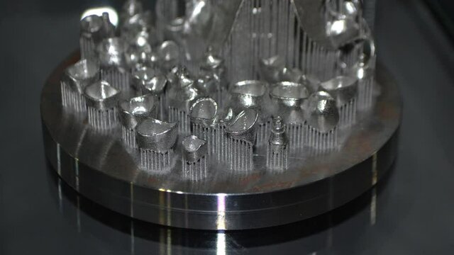 Object printed on metal 3d printer close-up. Object printed in laser sintering machine. Modern 3D printer printing from metal powder. Concept progressive additive DMLS, SLM, SLS 3d printing technology