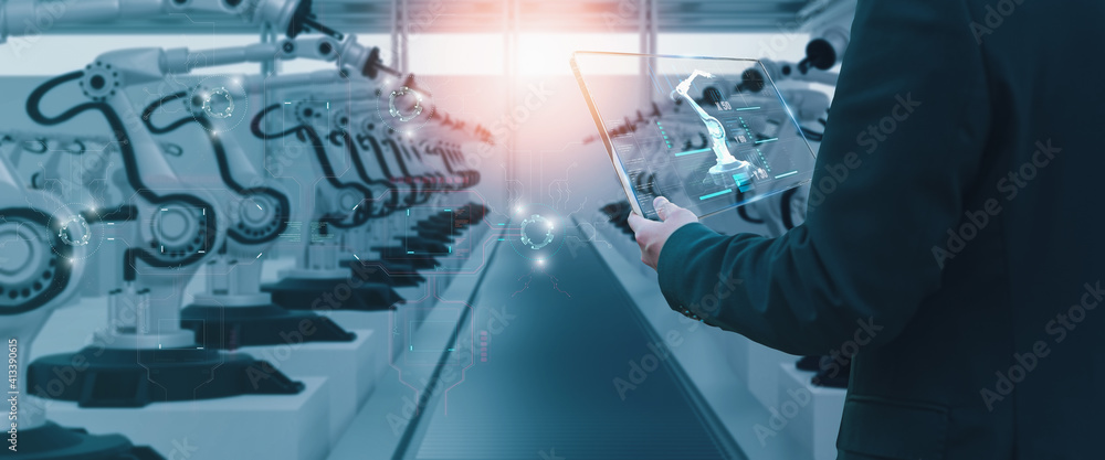 Wall mural industry engineer in factory,using smart tablet glass device,control automated robot arm machine lea
