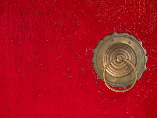 Vietnam, Hoi An. Old town historic district (UNESCO World Heritage Site). Fujian (Phuc Kien) Assembly Hall, built around 1690. Bonze handle on red door.