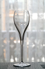 Transparent tall wine glass on a light background