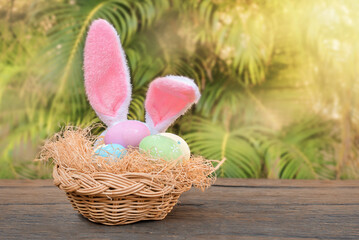 Easter eggs in a nest with Easter bunny ears.