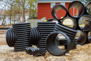 Plastic PVC pipes stacked in rows at a construction site on reconstruction of the city drain system