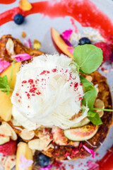 Strawberry cornflakes crusted French toasts with fresh summer fruit, coconut flakes topped with mascarpone, vanilla ice cream and silky smooth fairy floss