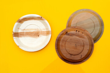 Betel palm leaf plate on yellow background.