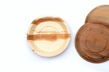 Betel palm leaf plates on white background.