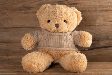 Teddy bear on old wood