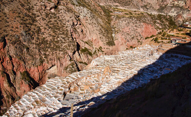 The beautiful landscapes and the stunning view of salt pans of Maras at sunset, Sacred Valley, Peru 
