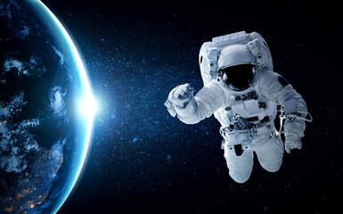 Astronaut spaceman do spacewalk while working for space station in outer space . Astronaut wear...