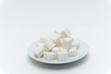 refined sugar sweets calories on a plate light background