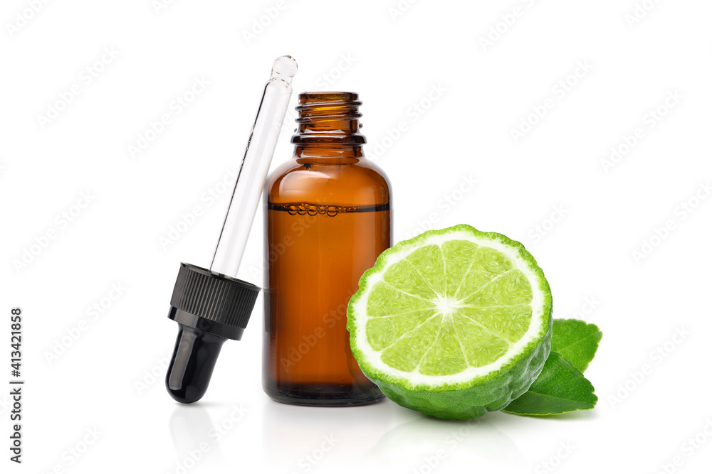 Wall mural Bergamot essential oil with bergamot fruit cut in half isolated on white background.