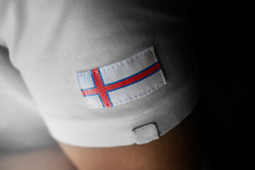 Patch of the national flag of the Faroe Islands on a white t-shirt