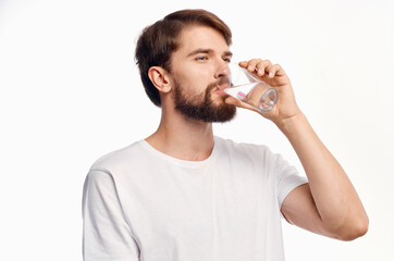 handsome man drinking water from a glass surprised look emotions white background