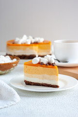 A slice of yellow layered cake cake, topped with marshmallow