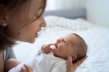 Pretty baby boy on mother hands in room closeup. Motherhood. Childhood. . High quality photo