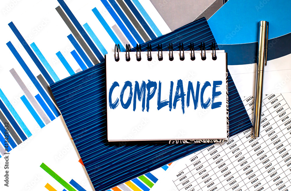 Poster notebook with text compliance on office table with office supplies on chart background