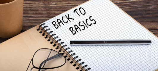 BACK TO BASICS words written in an office notebook. Concept in business.