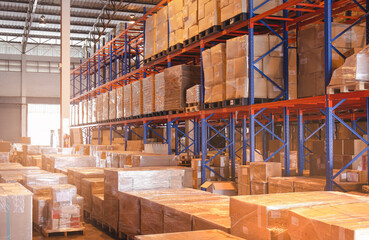 Interior of storage warehouse with tall shelves. Cargo shipment boxes. 