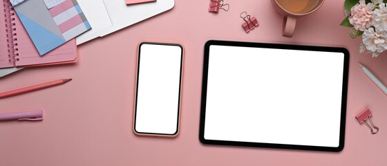 Horizontal image of modern feminine  workspace with digital tablet, smart phone, stationery and...
