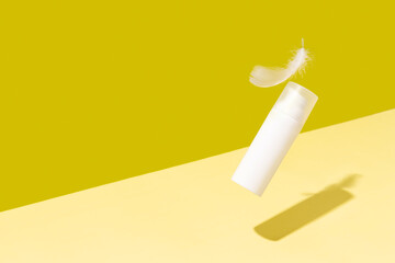 Creative layout with levitating beauty product on yellow background