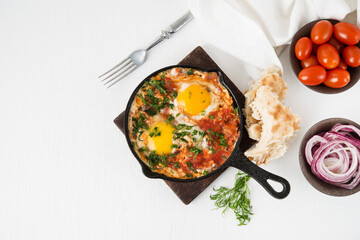 Shakshuka-a traditional Arabic dish made of eggs, peppers and tomatoes, top view