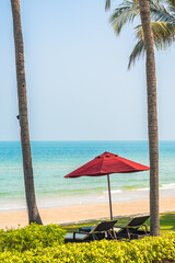 Empty deck chair lounge with umbrella around on beach sea ocean