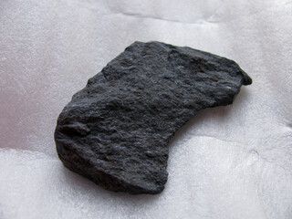 Flat piece of black rough corundum sandpaper