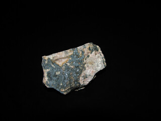 Rhodonite rock on a black background