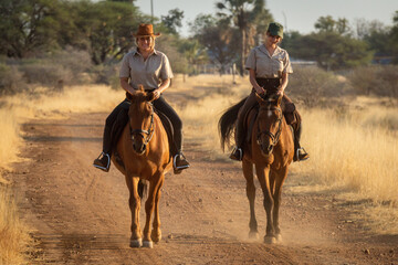 Smiling blonde and brunette ride along track